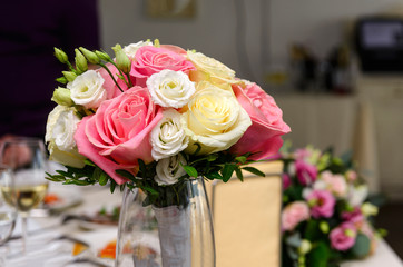 wedding bouquet of pink and white roses in a vase on the table