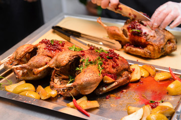cooked duck ,  cook's hands,  duck baked in its own juice with lingonberry sauce