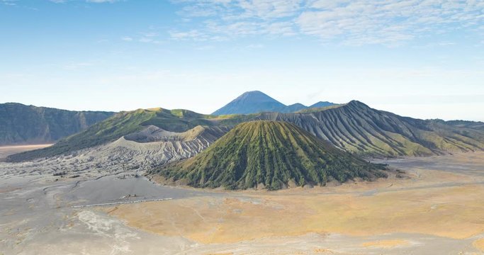 Bromo National Park, Indonesia - July 23, 2019: Panoramic timelapse of the Bromo volcano at sunrise, from the King Kong Hill viewpoint and the surrounding caldera, next to Batok Mountain and Semeru vo
