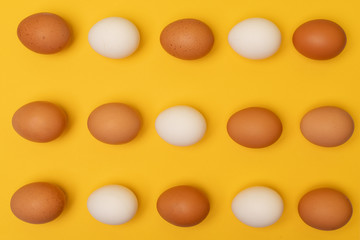 Easter eggs on a yellow background, place for an inscription in the center