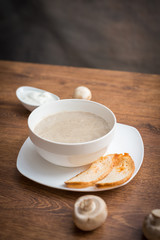 Fototapeta na wymiar Mushroom cream soup on wooden board.