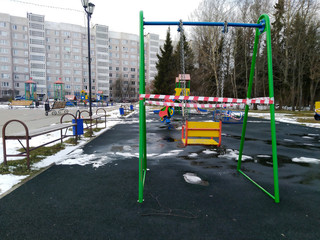 Stay home concept.Empty Swings In Playground closeup