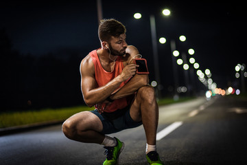 Man resting after night workout in the city.