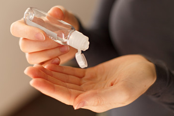 close-up of antiseptic in a bottle being poured on your hands.