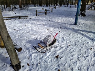 Wooden sleigh in snowy winter forest