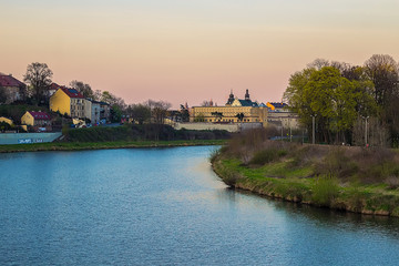 Obraz premium Convent of the Norbertine Sisters, located in the west of Krakow. Founded in 1148. Beautiful view from the Wisla River at sunset. Travel and religious landmark
