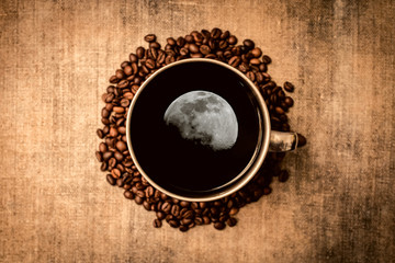 The moon is reflected in the coffee Cup. Mug with coffee top view