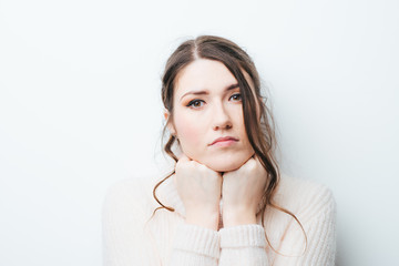 Obraz premium girl on a white background props chin fist