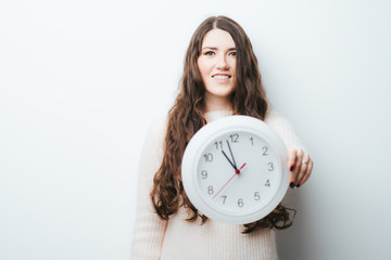 on a white background girl holding a clock in his hands