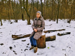 European woman resting in snowy winter forest © Samumneo