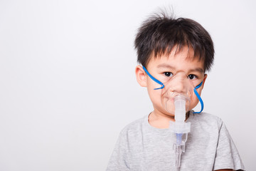 Closeup Asian face, Little children boy sick he using steam inhaler nebulizer mask inhalation...