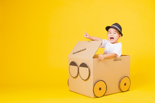 little children boy smile so happy driving car creative by cardboard