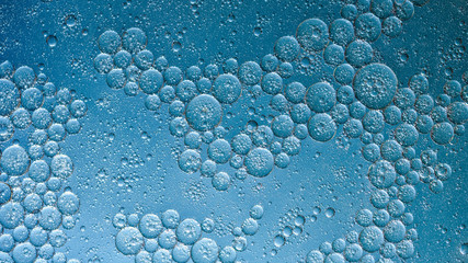 oil with bubbles on dark blue background. Abstract space background. Soft selective focus. macro of oil drops on water surface. copy space. air bubbles in water, gorizontal format, social media ready