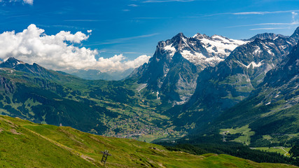 Fototapeta na wymiar Switzerland, Panoramic view on Grindelwald valley and Wetterhorn and green Alps around