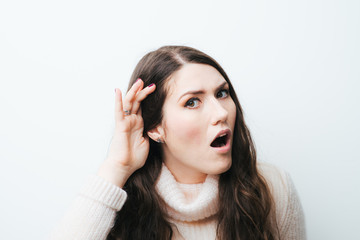 Fototapeta premium beautiful long-haired girl overhears on a white background