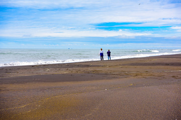 Icelandic family walking on the coast