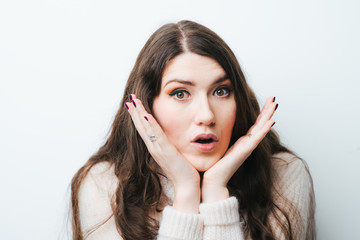 on a white background young girl with long hair scared