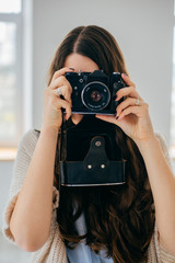 Close-up portrait of a  girl with a photocamera
