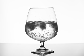 Glass cup with drink and ice