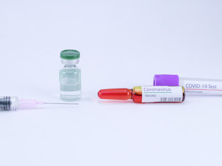 High angle shot of One empty blood sample tube, ampoule with Corona Vaccine label, a syringe and another medicine vial.