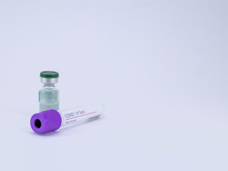 One Vaccine vial and an empty blood sample tube on white background for Corona virus test and cure.