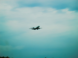 Fototapeta na wymiar illustration of a plane landing in the blue sky 