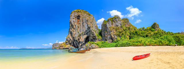 Turquoise crystal clear sea water with limestone cliff and mountain at Phra Nang Beach, Krabi, Thailand