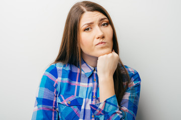 A young attractive woman holding her head