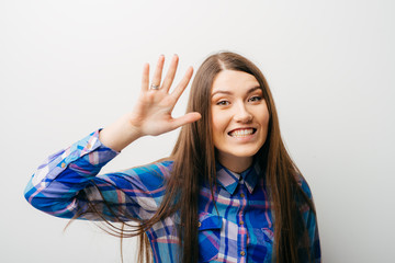 young woman waving, smiling