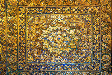 Metal bronze surface with floral ornament with many elements and and mother-of-pearl incrustation