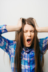 Young girl with hands on her head being desperate screaming