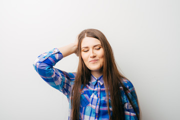 Pretty woman with hand on head gesturing migraine headache in white background