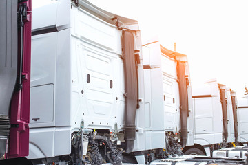 European trucks stand in a row with spacious comfortable cabs, industry. Copy space