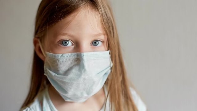self-isolation and quarantine, portrait of a girl in a medical mask, protection from viruses and diseases