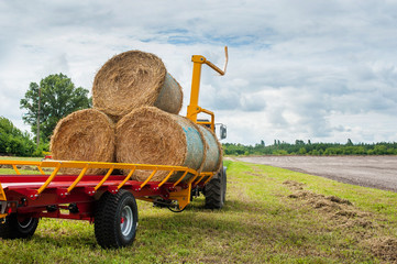 Straw on a trailer from a tractor in a field
