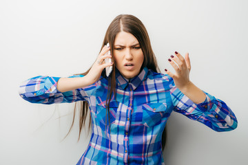 Unhappy woman fighting using mobile phone isolated on white background