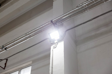 Modern LED spotlight for indoor lighting. The concept of conservation of electricity, lighting