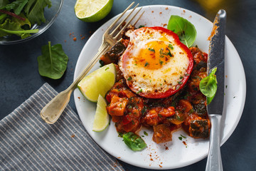 Fried egg with vegetables on plate