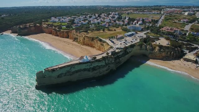 Aerial. Portuguese beach Senhora da Rocha, church on the cape, aerial view. Armacao de Pera Algarve