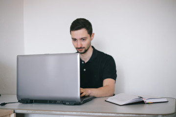 Young man working with a laptop