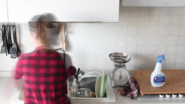 Timelapse a quick timelapse of a woman washing dishes in the kitchen