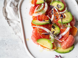 Citrus, avocado and fennel salad with dressing and purple sprouts. copy space