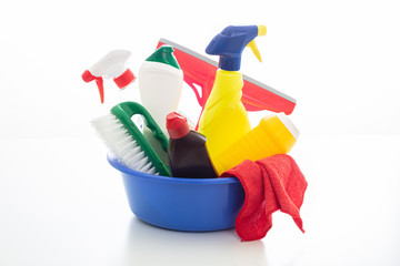 Cleaning supplies in a blue bowl isolated against white background.