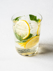 Homemade Summer citrus lemonade with ice in glass on white background.