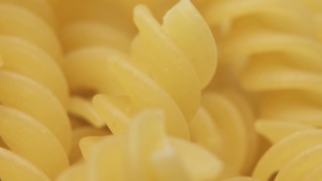 Italian pasta called fusilli , helical shape pasta. Macro close up