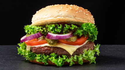 fresh tasty beef burger on dark background