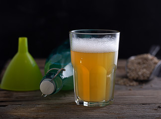 Homemade craft beer in a glass, dark wooden background