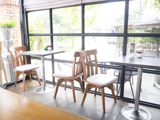 Cafe with brick cafe and bar interior , row of chairs near glass windows
