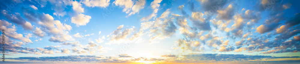 Wall mural blue sky clouds background. beautiful landscape with clouds and orange sun on sky