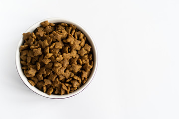 a bowl of dog food on a white surface